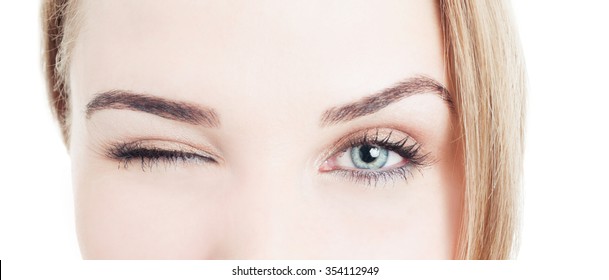 Close-up With Beautiful Woman Eyes And Wink Isolated On White