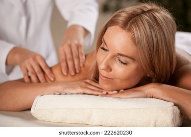 Closeup of beautiful woman having arm massage
