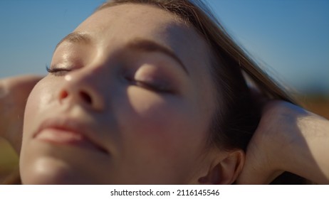 Closeup Beautiful Woman Putting Hands In Red Hair Outside. Young Woman Portrait Enjoying Head Self Massage Outdoors. Close Up Relaxed Girl Enjoying Summer In Sunny Day. Calm Female Touching Blond Hair