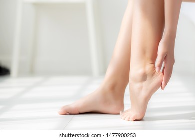 Closeup beautiful young asian woman applying cream and lotion onto foot dry on bed, beauty asia girl moisturizer and treatment cosmetic onto toes and heel, skincare cosmetic and healthy concept. - Shutterstock ID 1477900253