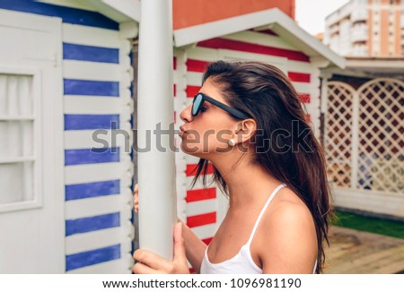 Similar – Young surfer woman with top and bikini kissing surfboard