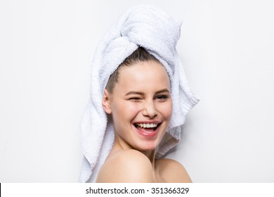 close-up of beautiful young woman with bath towel on head covering her breasts, on white - Powered by Shutterstock
