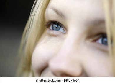 Closeup Of Beautiful Young Woman With Blue Eyes Looking Away