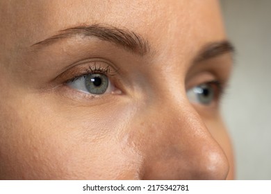 Close-up of a beautiful young woman with blue eyes looking sideways.  - Powered by Shutterstock