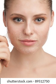 Close-up Of Beautiful Young Woman Removing Old Damaged Skin From Her Face