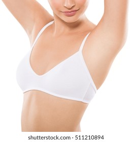Closeup of a beautiful young woman showing her smooth armpit isolated on white background. Girl holding her arms up and showing clean underarms. Hairs removal and depilation concept.