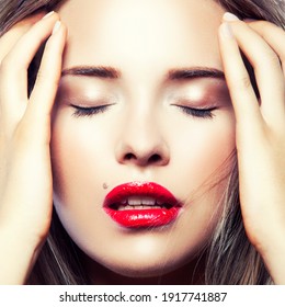 Close-up beauty face of attractive young girl. Red lips make-up, lip gloss, eye shadows, clean skin