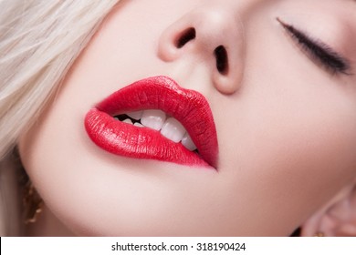 Close-up Beauty Portrait Model Big Sexy Lips, Mouth Open, White Teeth Bit her lower Lip, Seductive Lips Red. Macro image of Perfect Plump Lips. Beautiful Woman Bit her Lip  Passionately, white Teeth  