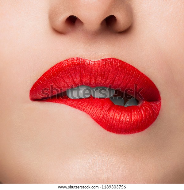 Close-up Beauty Portrait Model Big Sexy Lips, Mouth\
Open, White Teeth Bit her lower Lip, Seductive Lips Red. Macro\
image of Perfect Plump Lips. Beautiful Woman Bit her Lip\
Passionately, white\
Teeth