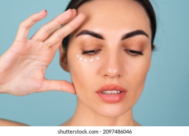 Close-up Beauty Portrait Of A Topless Woman With Perfect Skin And Natural Make-up, With Anti-aging Cream Dots To Moisturize And Firm The Skin Under The Eyes