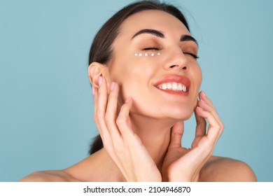 Close-up Beauty Portrait Of A Topless Woman With Perfect Skin And Natural Make-up, With Anti-aging Cream Dots To Moisturize And Firm The Skin Under The Eyes