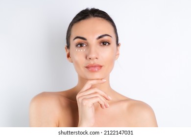 Close-up Beauty Portrait Of A Topless Woman With Perfect Skin And Natural Make-up, With Anti-aging Cream Dots To Moisturize And Firm The Skin Under The Eyes	