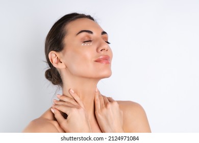 Close-up Beauty Portrait Of A Topless Woman With Perfect Skin And Natural Make-up, With Anti-aging Cream Dots To Moisturize And Firm The Skin Under The Eyes	