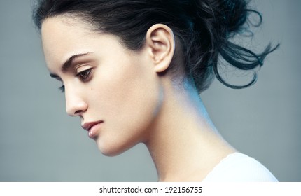 Closeup Beauty Portrait Of A Young Beautiful Brunette Woman. Muse. Profile, Looking Down.