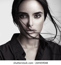 Closeup Beauty Portrait Of A Young Sensual Beautiful Brunette Girl With Long Black Straight Flying Hair. Smoky Eyes.