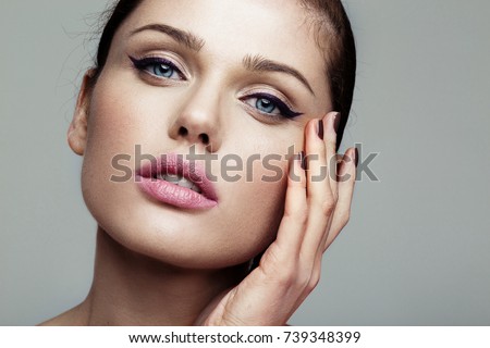 close-up beauty shot of young pretty model with bright make-up. Eyeliner. 