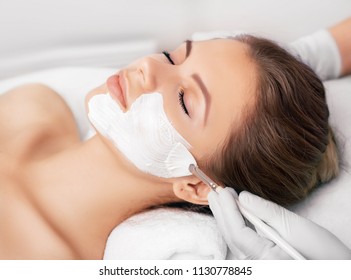 Closeup Of A Beauty Therapist Applying A Face Mask To A Woman With Perfect Freshh Skin. Cosmetology And Facial Skin Care