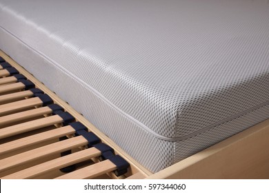 Close-up Of Bed With Cold Foam Mattress On Slatted Frame