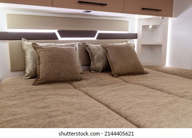 Closeup Of Bed And Pillows Inside Empty Bedroom In Luxury RV Camper Trailer Interior