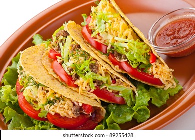 Closeup Of Beef Tacos Served With Salad And Fresh Tomatoes Salsa On White Background