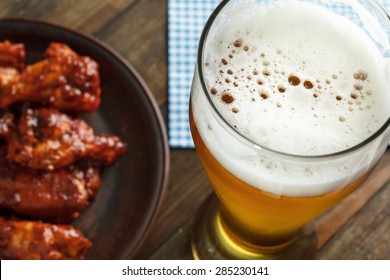 Close-up Of Beer And Buffalo Wings On Wooden Table