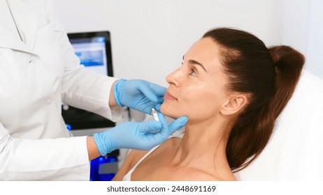 Close-up. Before the procedure for facial contouring or plastic surgery, the cosmetologist makes markings on the patient’s face. Time to prepare for a cosmetic procedure. - Powered by Shutterstock