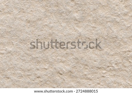 Close-up of the beige surface of the rough gres tile, classified as the highest slip resistance class (R13).