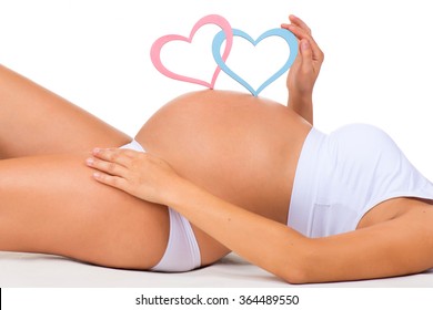 Close-up Belly Of Pregnant Woman. Gender: Boy, Girl Or Twins? Two Hearts