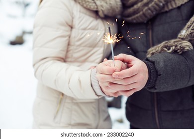Close-up of Bengal light in hands of lovers