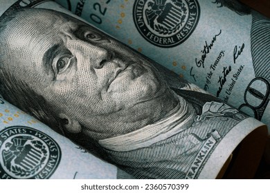 Closeup of Benjamin Franklin face on USD dollar banknote for dollar is the main of currency exchange in the world.