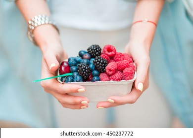 Closeup berries fruits at female hands. Blueberries, raspberries, strawberries, cherries and blackberries on the market. Gardening, agriculture, harvest and forest concept. - Powered by Shutterstock