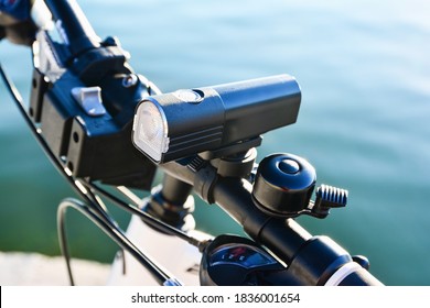 Close-up Of Bicycle Front Light And Bell On A Handlebar. Bicycle Accessories.