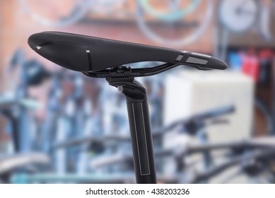 closeup of a bicycle saddle in the seat post  on  bicycle shop background.