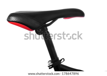 closeup of a bicycle saddle in the seat post on a white background
