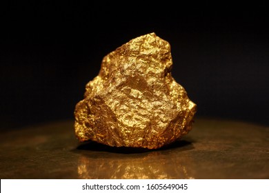 Closeup Of Big Gold Nugget. Finance And Business Concept. Gold Ore Found In The Mine. Trade And Exchange.