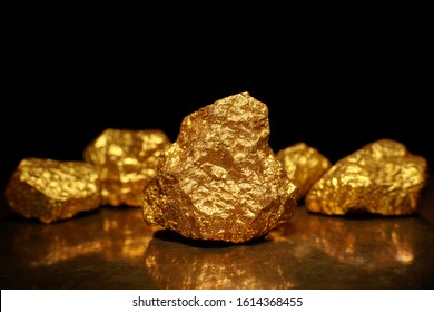 Closeup Of Big Gold Nugget. Finance And Business Concept. Gold Ore Found In The Mine. Trade And Exchange.