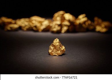 Closeup big gold nugget black background