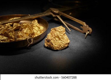 Closeup of big gold nugget and scales copper
