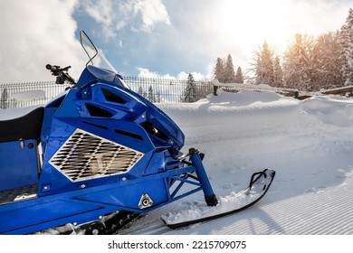 Close-up Big Modern Snow Mobile Scooter Atv Vehicle Forest Road Against Sunrise Sunny Sky On Cold Snowy Winter Day. Snowmobile Rental Sport Adventure Trip Service. Arctic Nordic Snow Sledge Transport