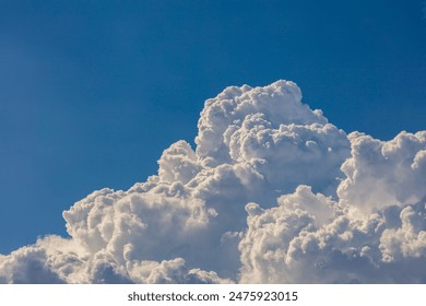 Closeup of Billowy cumulus clouds. Wispy clouds, deep blue sky in background. 
 - Powered by Shutterstock