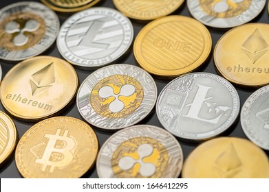 Close-up Of Bitcoin And Other Electronic Money Coins Lie Next To Each Other On A Black Surface. Concept Of Modern Currency And Stable Currency