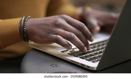 Close-up Black African Man Hands Typing On Laptop Computer