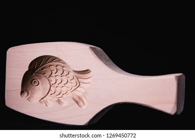 Closeup black background isolated fish pie printing mold - Powered by Shutterstock