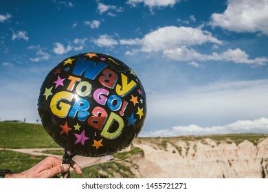 A Closeup Of A Black Balloon With A Writing 