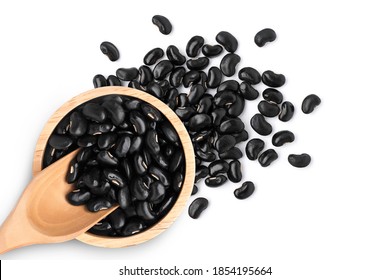 Closeup black beans ( Urad dal, black gram, vigna mungo ) in wooden bowl isolated on white background. Top view. Flatlay.