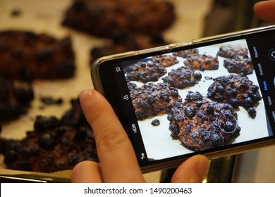 Closeup Black Burnt Oatmeal Cookies With Raisins. Take Picture On Mobile Phone Of Bad Result Of Cooking. Forget To Turn Off The Oven With Cooking Products