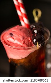 A Closeup Of Black Cherry Cocktail With Straw