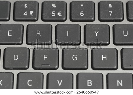 Close-up of a black computer keyboard, QWERTY layout.