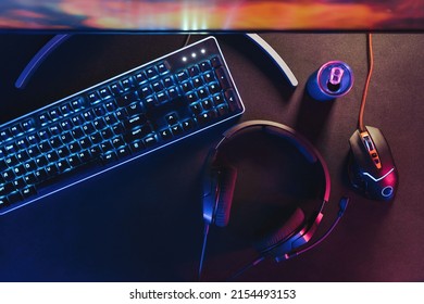 Close-up of black desktop with professional gaming and streaming setup, keyboard, monitor, computer mouse, headset. Gamer's equipment ready for online championship and streaming. Cyber sport concept - Shutterstock ID 2154493153