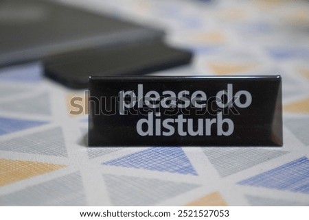 A closeup of a black desktop sign with the text 